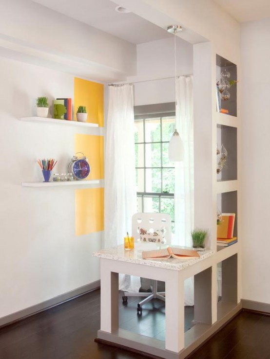 a touch of sunny yellow paint on the wall, a yellow glass and some grass in a glass for a spring feel in the space