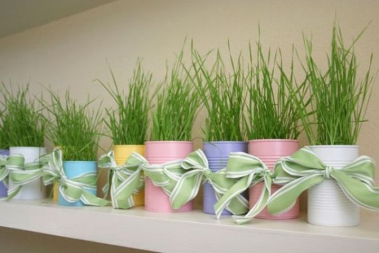 pastel tin cans with wheatgrass and green bows is great for spring decor and will fill the space with color