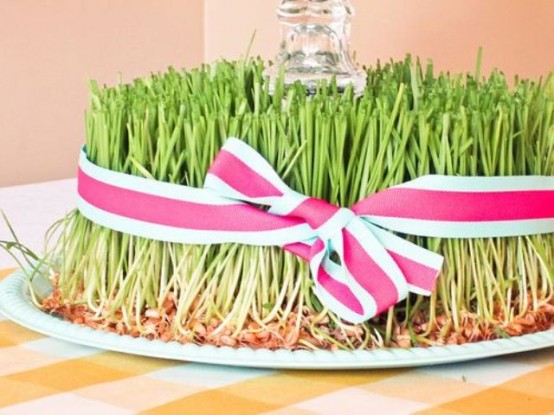 a spring wheatgrass decoration with a glass in the center and a striped ribbon bow is vivacious and cool