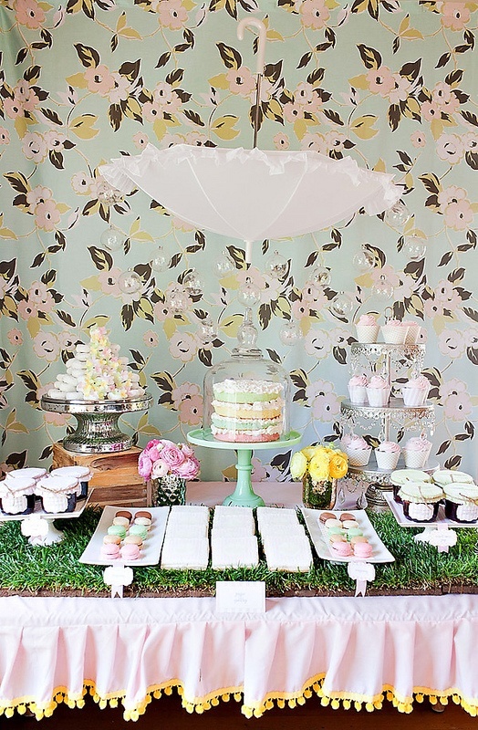 wheatgrass in a tray is used as a backdrop for a dessert table to give it a fresh spring feel