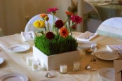 a white box planter with wheatgrass and bold blooms can be used as a spring centerpiece, candles will add to it