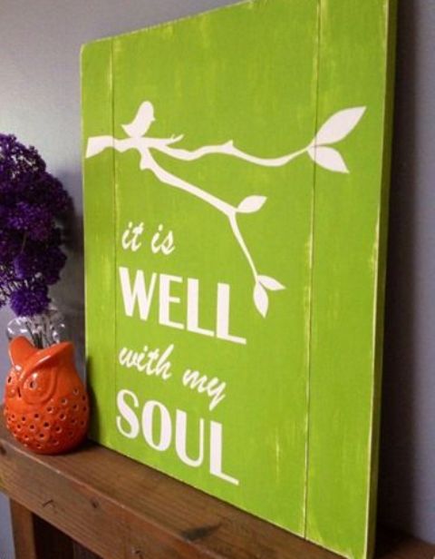 a bright green sign with branches and a bird plus some tenciled letters is a colorful and bold idea for spring