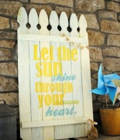 a bold rustic sprign sign in white with blue and yellow letters feels and looks very spring-like