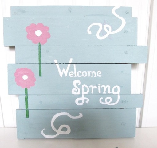 a blue spring sign with pretty pink blooms and white letters is a lovely and pretty pastel decoration for spring