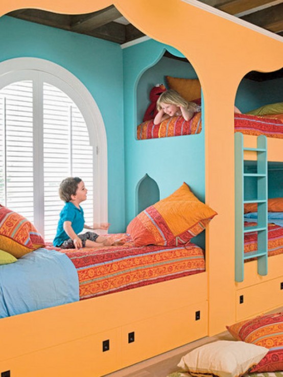 a colorful shared kid's room with an orange and blue bunk bed and colorful bedding, bright printed pillows feels a bit Moroccan