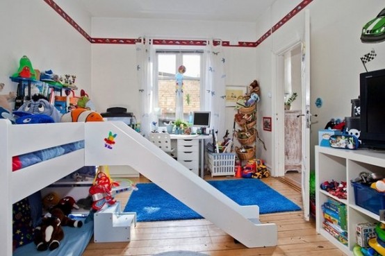 a white kid's room with colorful decor and items, a bed with a slider, bright bedding and a rug, colorful toys and decor