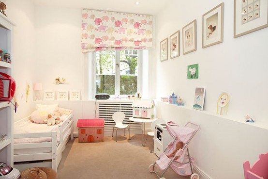 a neutral kid's room with a cozy white bed with pink bedding, a dollhouse and other toys, printed textiles and some artwork is amazing and very welcoming