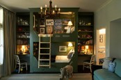 a moody green kid’s room with a built-in bunk bed with lights and shelves, studying spaces, a sofa and some striped textiles