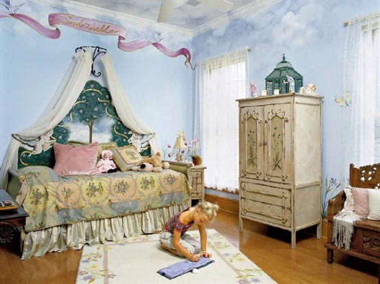 a chic vintage kid's room with sky painted on the walls, refined vintage furniture, printed textiles and a carved wooden bench