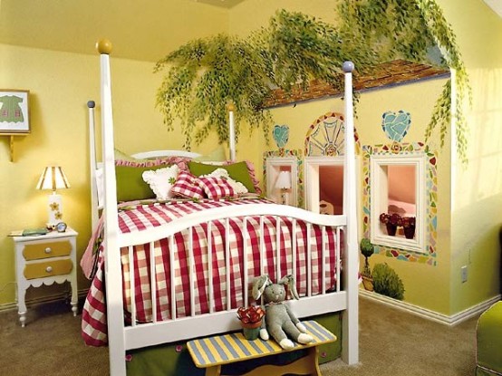 a bold kid's room with yellow walls and a ceiling, painted greenery and mosaics on the walls, a white bed and red and white bedding, some art and a table lamp