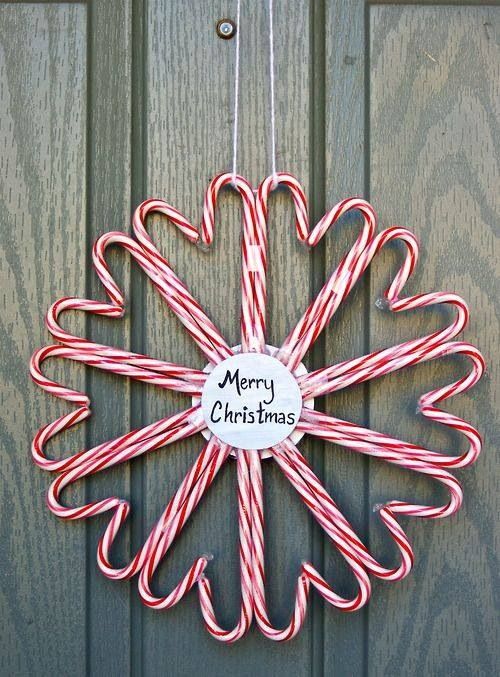 a large candy cane wreath with a tag inside is a very fun and easy decor idea for the holidays