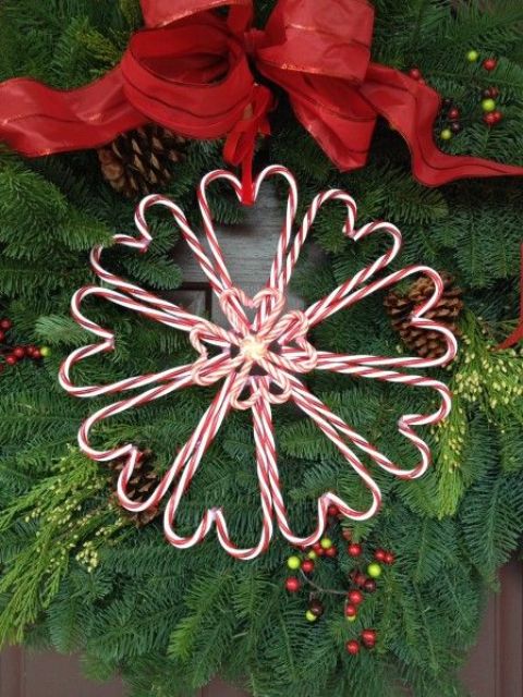 a cute candy cane heart-shaped wreath for Christmas with a large red bow is a lovely decoration for Christmas you can DIY anytime