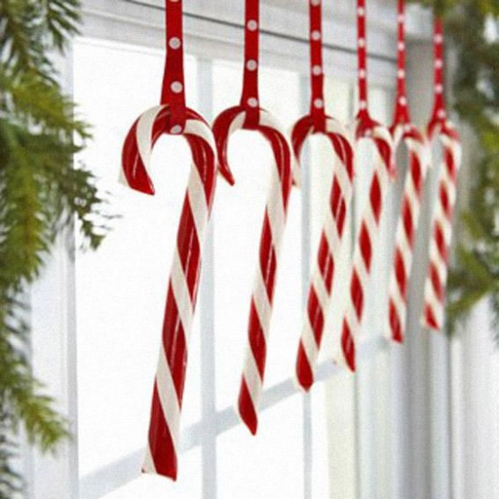 candy cane window decor with fir branches is a chic and lovely idea for whimsical and fun Christmas decor