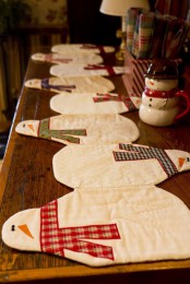 a bright snowman table runner with colorful scarves is a cool idea for a Christmas tablescape and you can DIY one