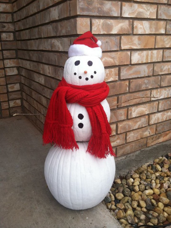 an outdoor snowman decoration made of white pumpkins, buttons, a red scarf and a red hat is a cool idea for a winter space