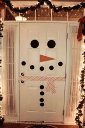 a front door styled as a snowman created with colorful washi tape is a great idea to add a bit of fun to your space
