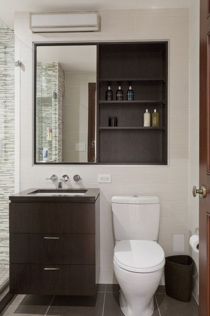 a built-in storage unit that features mirror sliding doors is a lovely idea for a modern bathroom and it looks very sleek and clean