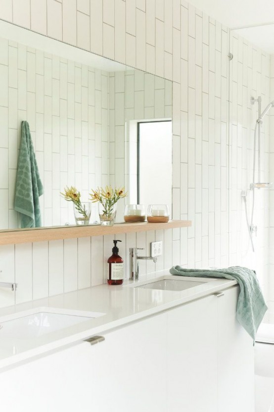 a large mirror with a shelf for storage is a cool idea for a contemporary bathroom - you get a large mirror, a lot of storage space and no bulky pieces