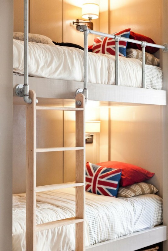 neutral bunk beds and tube railing, wall sconces, a wooden ladder and bright pillows for a colorful accent