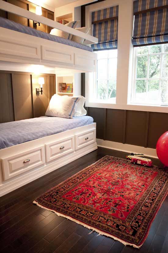 rustic white wooden bunk beds, wall sconces and railing along the upper bed to keep the kid secure