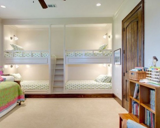 kids' bunk bed units for four, with wall sconces and a single ladder between the bed blocks