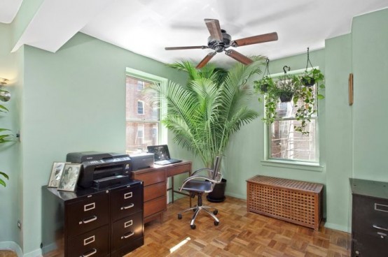 a home office with a dark stained IKEA Hol table that features much storage and doubles as a bench