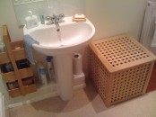 a small IKEA Hol table used in the bathroom to store things inside and outside too