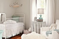 a neutral farmhouse nursery with grey walls, vintage furniture, white and printed textiles and touches of mint blue