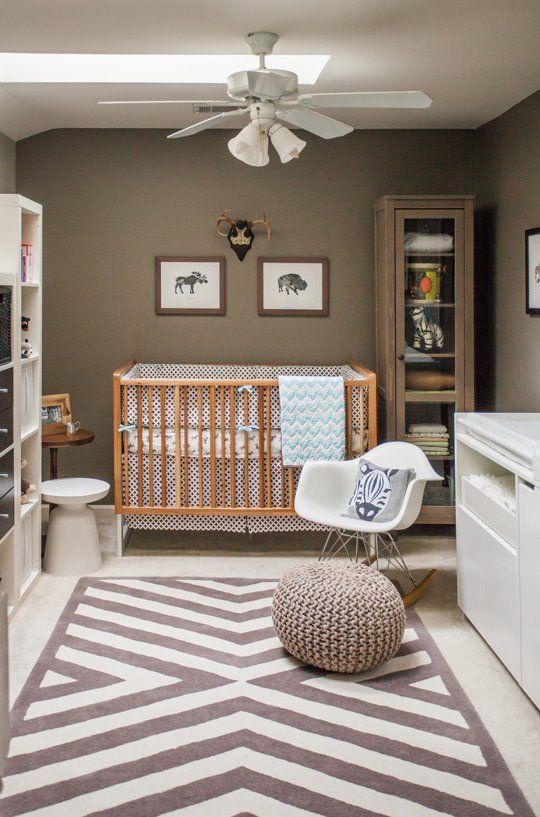 a gender-neutral nursery with taupe walls, white and neutral furniture, printed textiles and a skylight on the ceiling