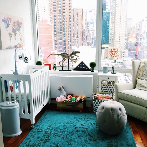 a gender neutral nursery with a view, bold printed and colorful textiles, rather neutral furniture, colorful toys is a cool idea