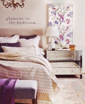 a neutral glam bedroom refreshed with floral prints and purple touches, neutral textiles and a mirror nightstand