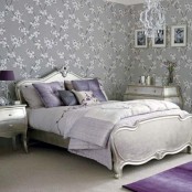 a romantic pastel glam bedroom with grey printed walls, refined furniture, touches of lilac and purple