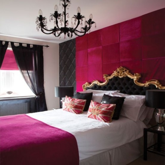 a glam fuchsia and black bedroom with a refined bed, a black chandelier and touches of gold for a bright look