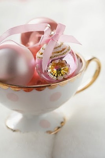a vintage teacup with delicate pastel pink vintage Christmas ornaments is a beautiful decoration for the holidays