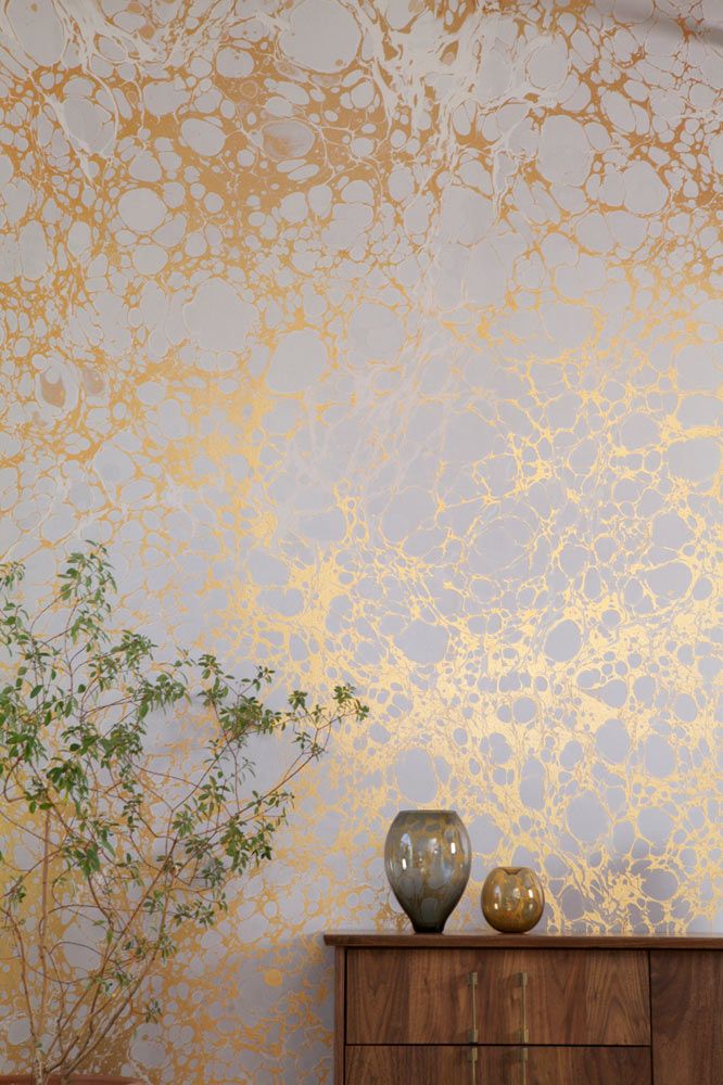 gold and white marble wallpaper is a beautiful accent to the space and a glam touch, it will work for many styles