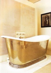 a fabulous bathtub covered with polished metal sheets with a gold finish looks fantastic and brigns a glam feel to the space