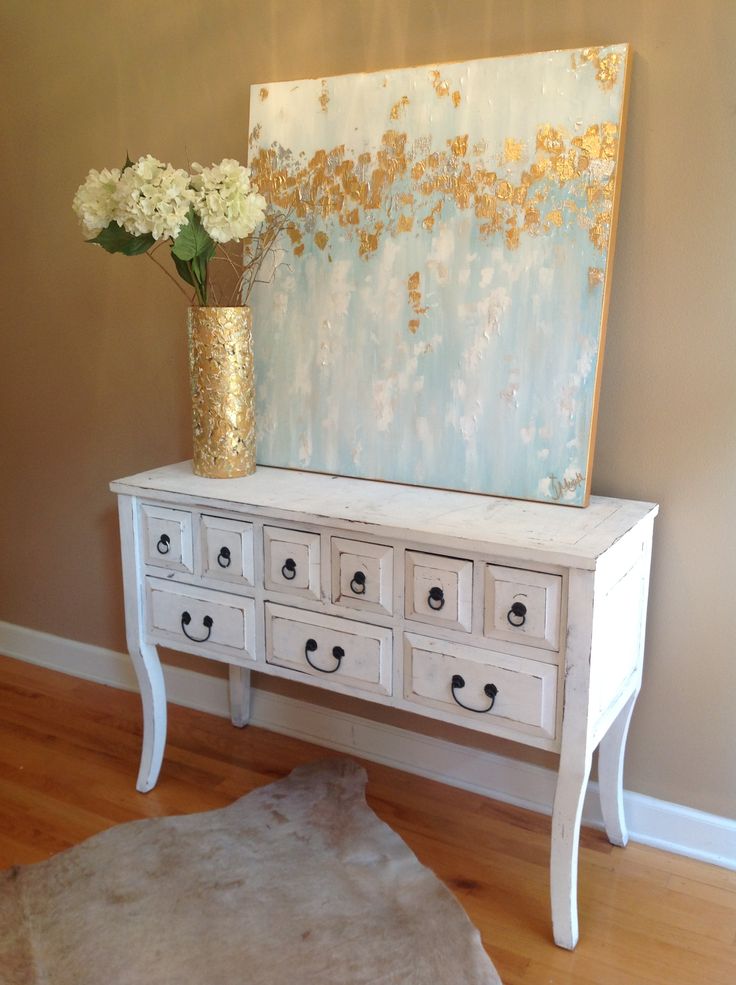 a gold foil vase and an abstract artwork with light blues and gold foil touches is a lovely idea