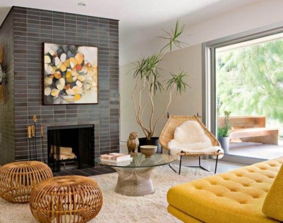 a welcoming mid-century modern living room with a brick clad fireplace, a mustard sofa, wooden coffee tables and a white chair, a glass wall for natural light