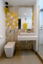a stylish contemporary geometric bathroom with geometric tiles with an ombre effect and square appliances looks very chic and bold