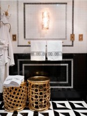 an exquisite black and white bathroom with a geo tile floor, a catchy color block tile wall, refined gold stools
