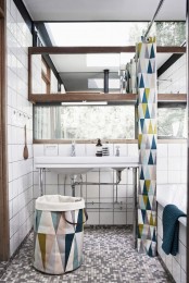 a neutral farmhouse bathroom with a geo printed shower curtain, a matching fabric basket is a chic and stylish space