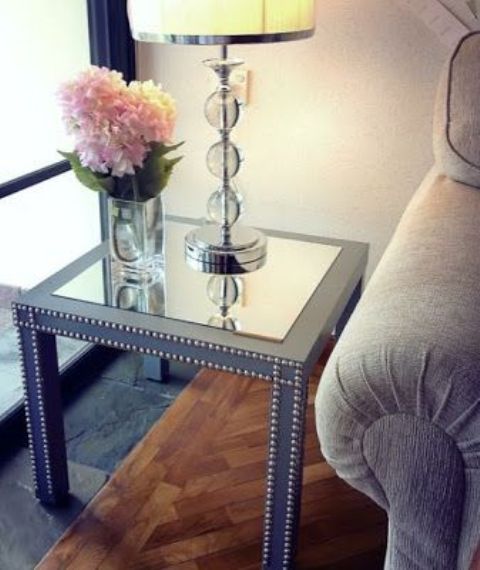 a grey IKEA Lack table hack with a mirror tabletop and decorative nails is a gorgeous idea for a glam and chic living room