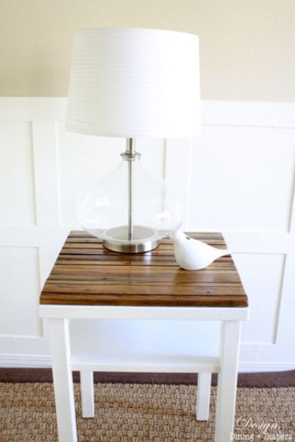 an IKEA Lack table turned into a nightstand with a rustic stained wood tabletop is a chic and stylish idea for a rustic space