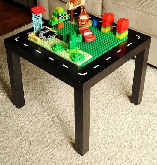 an IKEA Lack table turned into a kids' playtable - it's painted black and on top you may see a surface for playing LEGO