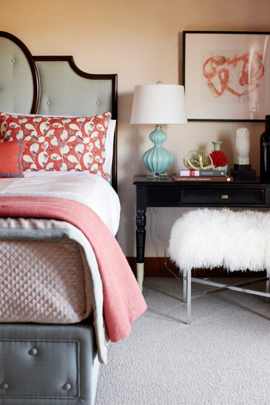 a bright bedroom done in ocher, coral and grey, with dark stained wooden touches plus dark furniture