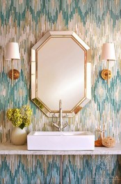 a bright guest toilet with a geometric mirror, bright printed wallpaper, a square sink