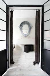an eclectic guest toilet done in neutrals, a large wall-mounted sink and a mirror in a patina frame