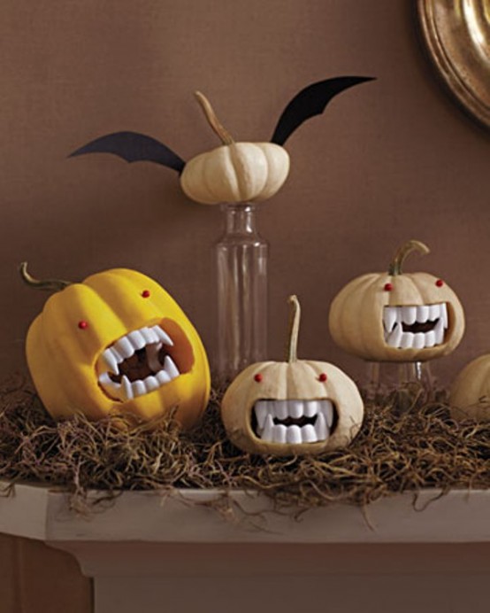 cut out pumpkins and insert vampire fangs inside to make easy and fun Halloween party decor