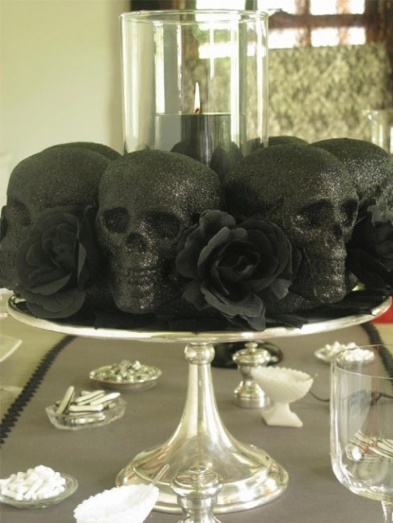 a metallic dish with black skulls and black blooms is a simple last-minute decoration for Halloween