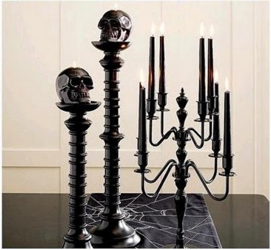 a black candelabra with black candles, black stands with black skulls are amazing for Halloween decor, they will add a chic and bold touch to your space